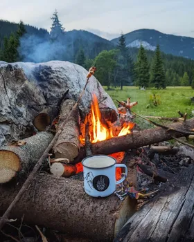 white coffee cup next to fireplace